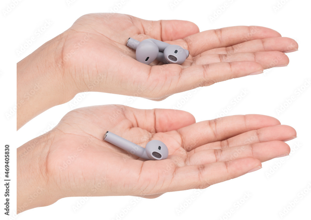Set of Hand holding Grey wireless headphones isolated on a white background.