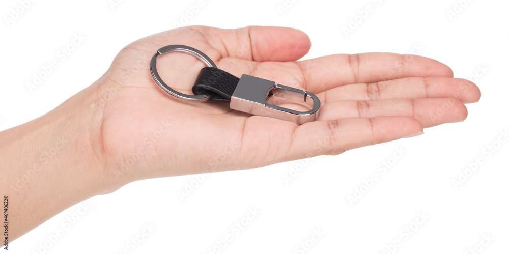 Hand holding Metal keychain with a small rectangle on a black strap isolated on a white background. Hand holding Metal keychain with a small rectangle on a black strap isolated on a white background.