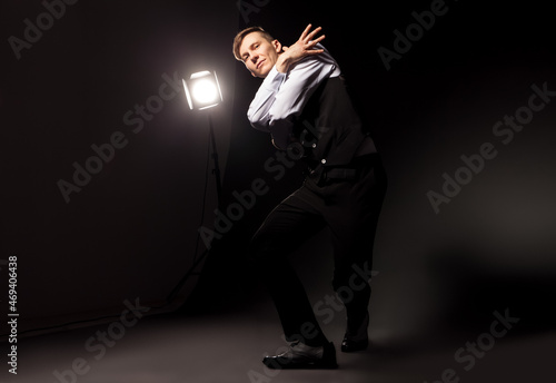 modern style dancer dancing on studio dark background