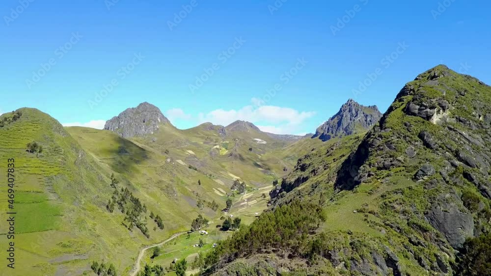 Valley of mountain ranges with forestry slopes and clouds sailing by, aerial drone view Valley of mountain ranges with forestry slopes and clouds sailing by, aerial drone view