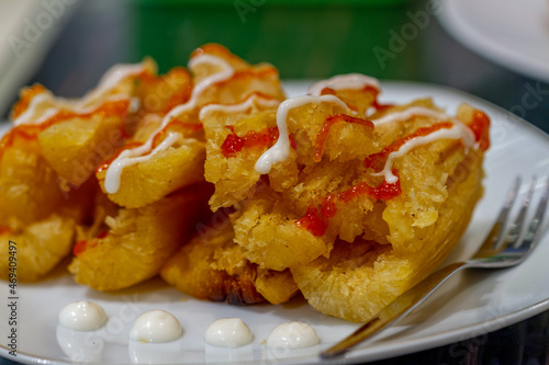 Fried cassava served with cafe-style sauce and mayonnaise, usually consumed with tea or coffee, oily and high-calorie