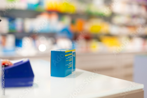 Box with medicines or pills on shelf in a modern pharmacy close up
