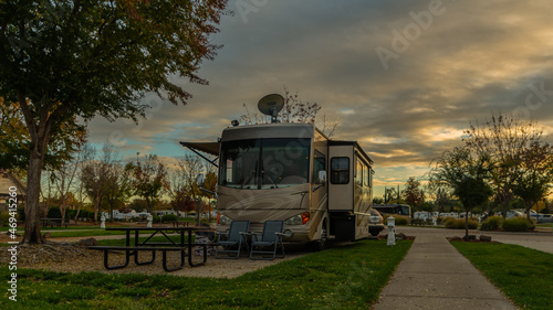Fotografering Motorhome parked at a campsite under a cloudy sky