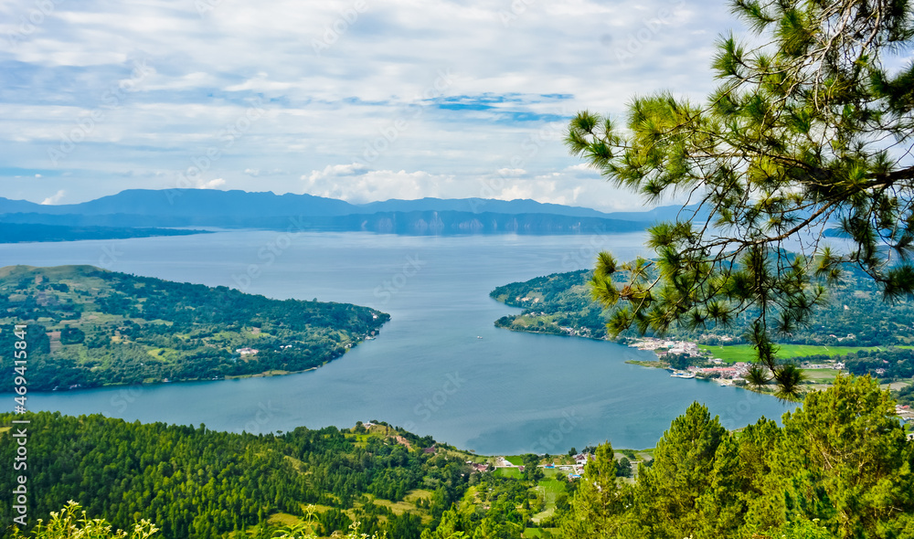 Fototapeta premium The beauty of Lake Toba which is a caldera lake comes from an ancient volcanic eruption and is the largest volcanic lake in the world. View from geosite hutaginjang. North Sumatra, Indonesia