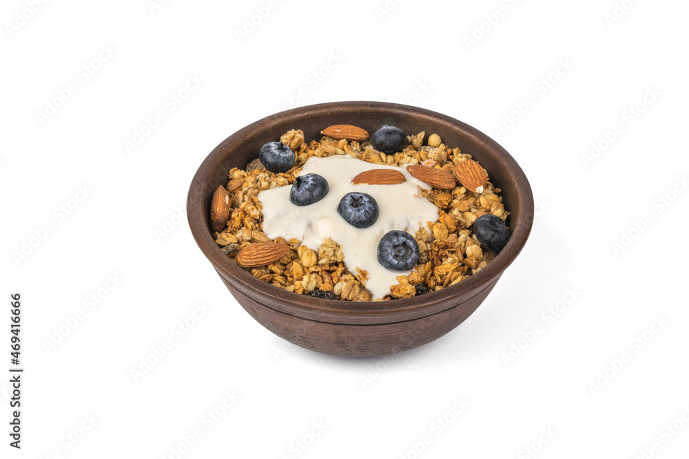 Deep clay bowl with muesli and yogurt isolated on a white background. Deep clay bowl with muesli and yogurt isolated on a white background.