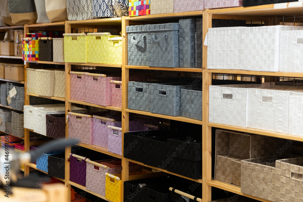 Variety of storage boxes and baskets on shelves at modern furnishings store