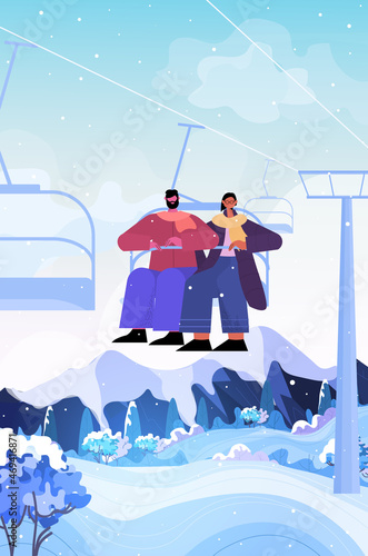 people sitting on chairlift ski resort cableway in snowy mountains christmas new year holidays celebration