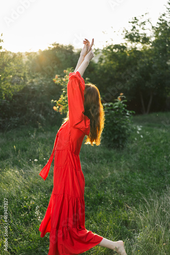 attractive woman in red dress outdoors in freedom field