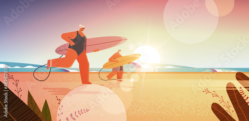 senior couple with surf boards aged man woman surfers holding surfboards summer vacation active old age concept