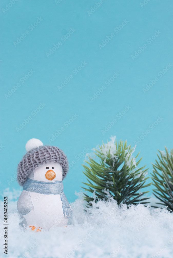 Obraz premium Toy penguin on the snow and blue background. The minimalistic style of the New Year's card.