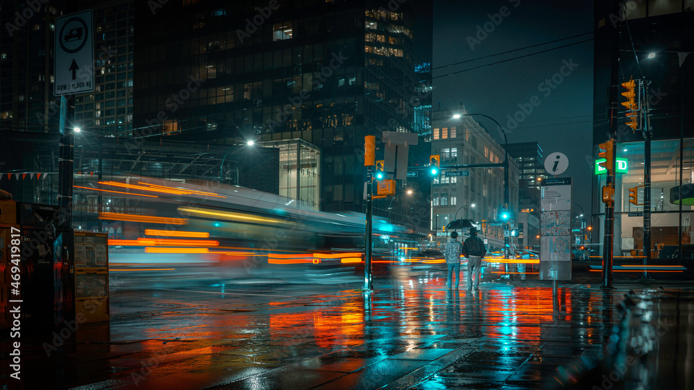 Naklejka premium Vancouver Canada - November 14, 2021: Long exposure photograph of cars passing at night in Downtown Vancouver British Columbia.