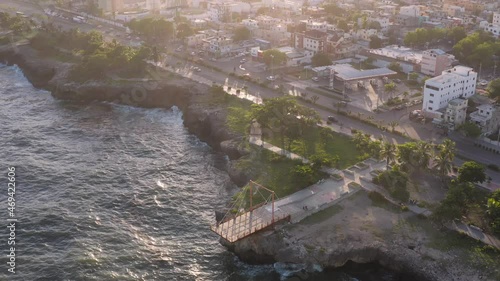 Ramp structure built for fishermen of Santo Domingo to enjoy fishing in Dominican Republic. Aerial rising circling view photo