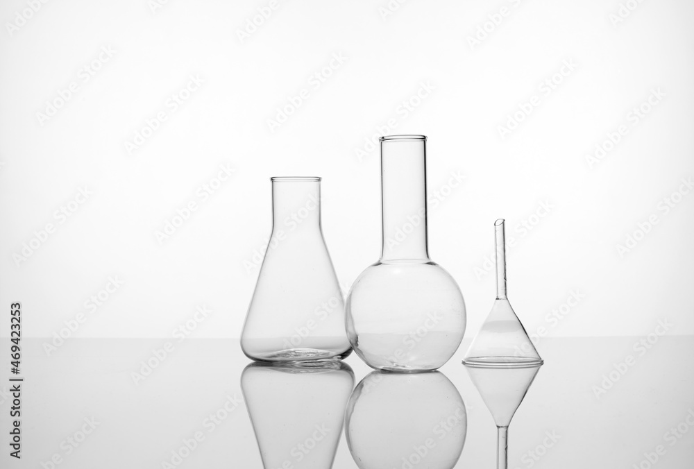 Laboratory equipment beakers, flask, tubes and petri dish in white environment with backlight Laboratory equipment beakers, flask, tubes and petri dish in white environment with backlight