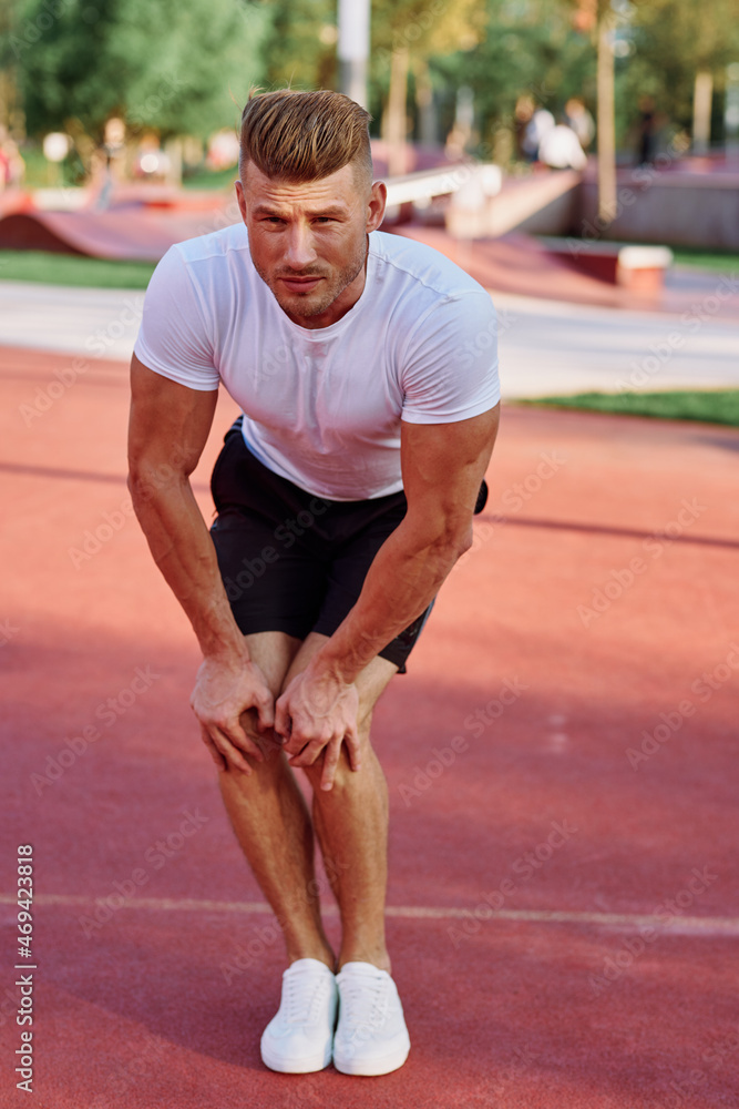 man in white t-shirt on the sports ground workout motivation