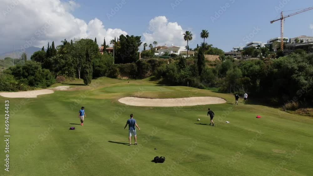 Luxury golf course in Marbella, with lake, golfers, luxurious houses Luxury golf course in Marbella, with lake, golfers, luxurious houses