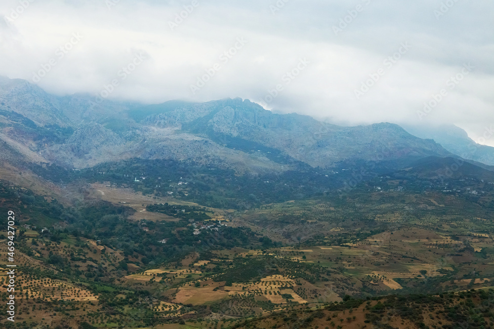 Moroccan landscape with foggy mountains and fields. Moroccan landscape with foggy mountains and fields.