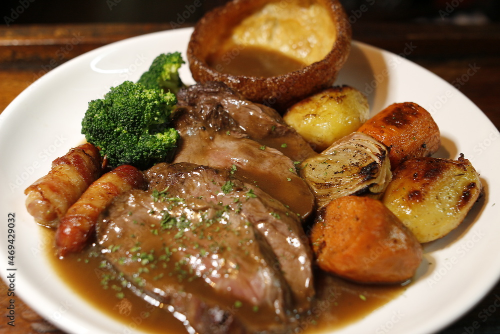 Sunday roast dinner lamb pork should with cracking meet Stock Photo