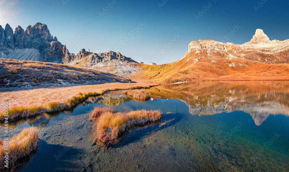 Paterno peak reflected in the Calm waters of Piani lake. Bright autumn view of Dolomite alps. Gorgeous morning scene of Tre Cime Di Laveredo National Park, Italy. Beauty of nature concept background..