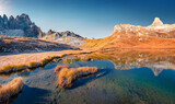 Paterno peak reflected in the Calm waters of Piani lake. Bright autumn view of Dolomite alps. Gorgeous morning scene of Tre Cime Di Laveredo National Park, Italy. Beauty of nature concept background..