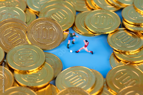 Miniature creative football players in the game of gold coins