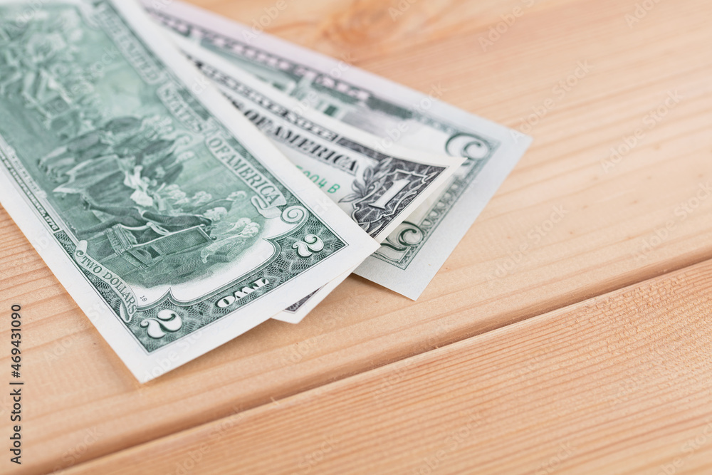 Dollar bills on wooden background Dollar bills on wooden background
