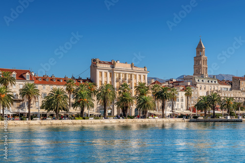 Beautiful view of waterfront promenade in old town Split with cafe, restaurants and palm trees and the Diocletian's Palace in Adriatic sea coast, Split, Croatia.