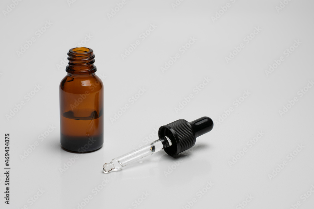 Essential serum oil in amber dropper bottle isolate on white background. Essential serum oil in amber dropper bottle isolate on white background.