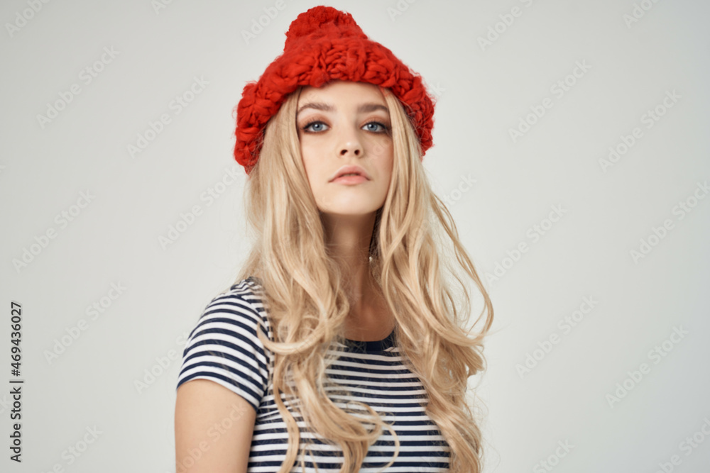 beautiful woman in fashionable clothes Red Hat light background beautiful woman in fashionable clothes Red Hat light background