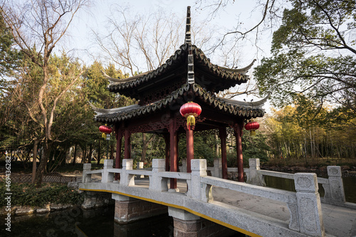 Traditional Chinese pavilion and bridge in a park autumn scenery