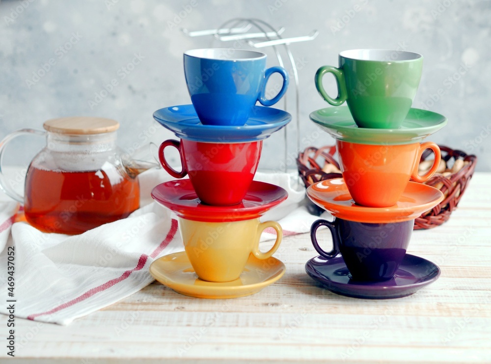 Bright multi colored tea cups cheer you up. Porcelain kitchen utensils. Bright multi colored tea cups cheer you up. Porcelain kitchen utensils.