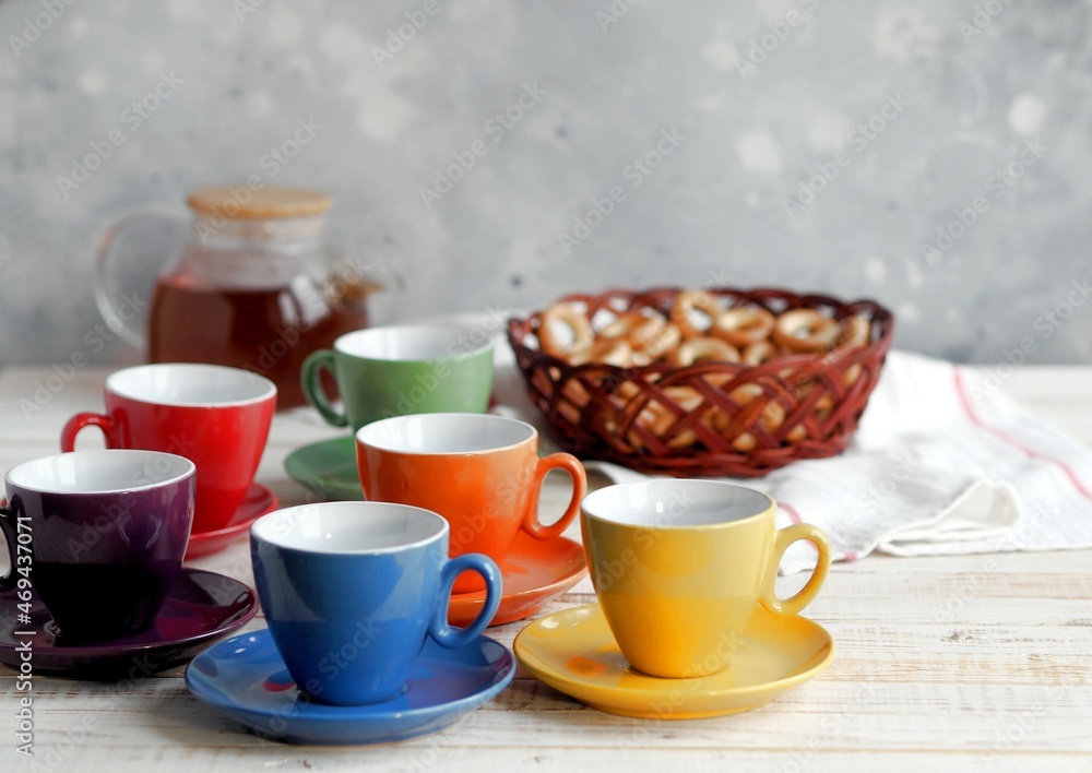 Bright multi colored tea cups cheer you up. Porcelain kitchen utensils. Bright multi colored tea cups cheer you up. Porcelain kitchen utensils.