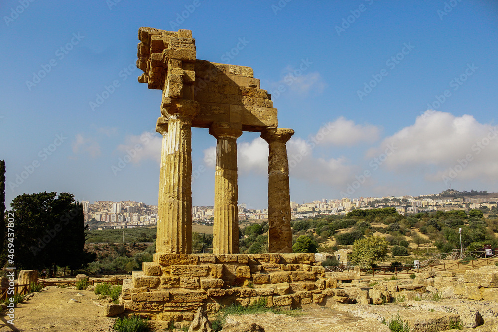 Valle dei templi archeological park ancient ruins view with Agrigento town on the background, Sicily, Italy