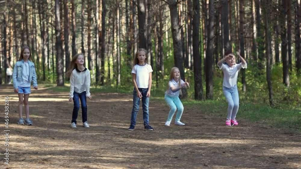 Portrait of jumping children in the summer forest. Group of five teenagers. Portrait of jumping children in the summer forest. Group of five teenagers.