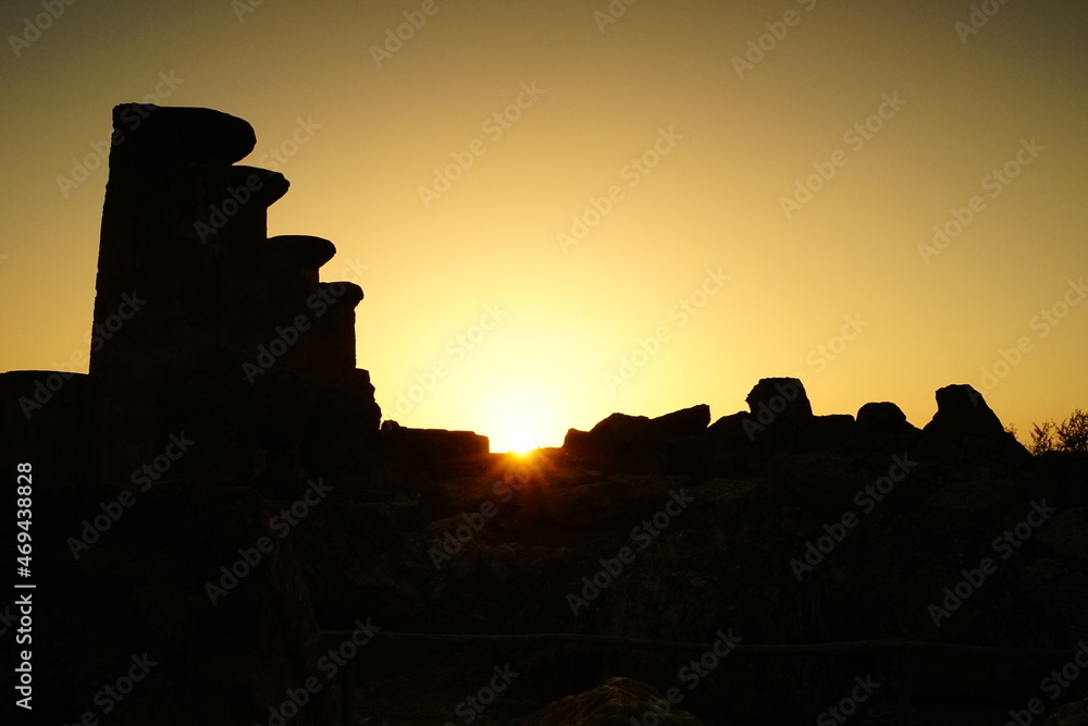 Fading sun at the sunset over ancient greek temple ruins