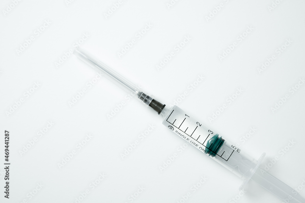 Fototapeta premium Medical syringe and needle with medicament on a light background