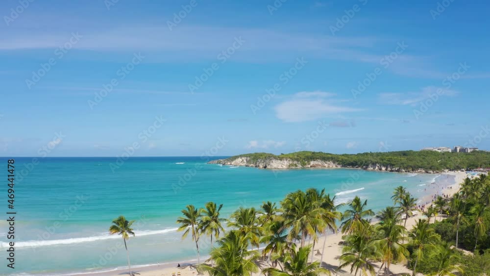 Tall coconut trees on the beach of the Macao Republic of the Dominican Republic. Travel to Macao Beach, a white sand beach and bright blue sea. Island in the Atlantic Ocean landscape. Tall coconut trees on the beach of the Macao Republic of the Dominican Republic. Travel to Macao Beach, a white sand beach and bright blue sea. Island in the Atlantic Ocean landscape.
