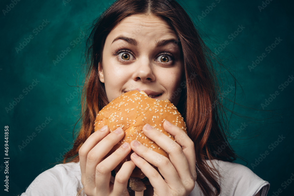 woman eating hamburger fast food snack close-up woman eating hamburger fast food snack close-up
