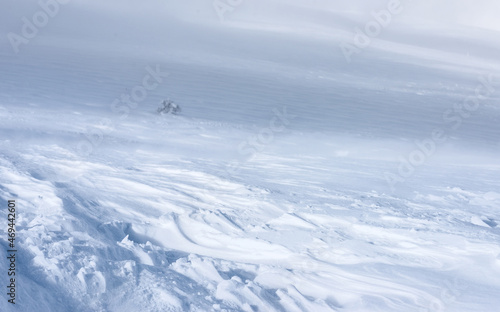 A mountain slope covered with a layer of snow.