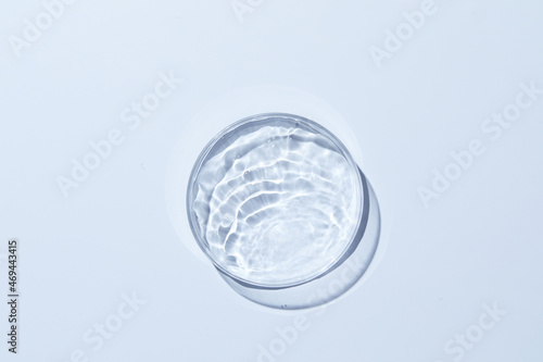 Petri dish with water and ripple in blue background