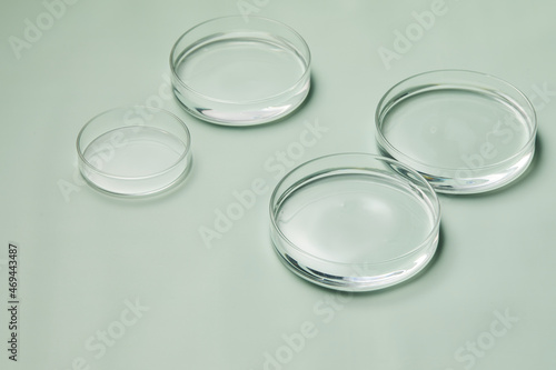 Petri dishes with water and ripple in green background