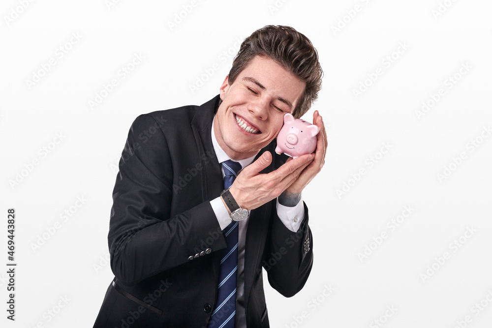 Happy investor in formal suit embracing piggy bank Happy investor in formal suit embracing piggy bank