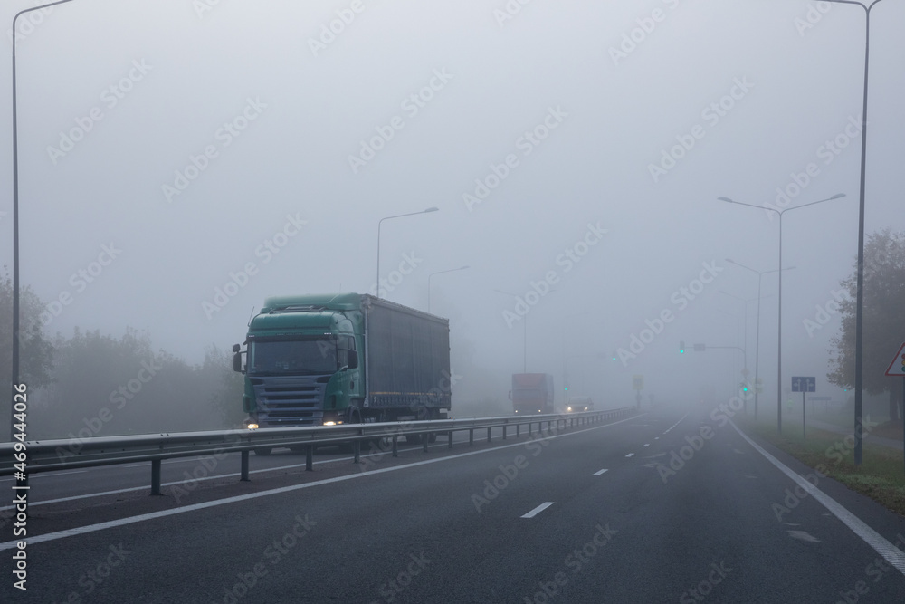 Truck on a road in the fog. Poor visibility conditions on the road