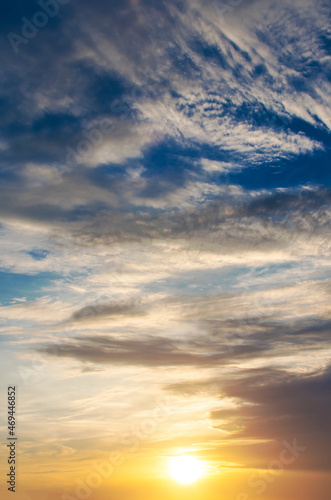 Cloudy sunrise in the sky with bright sun in the clouds. © Sviatoslav Khomiakov