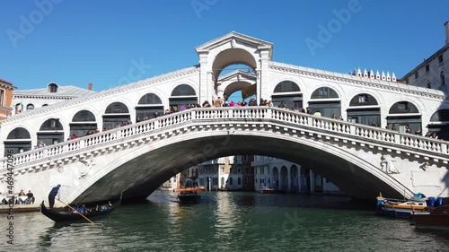 Europe, Italy, Venice November 2021 - Gondolas in Canal Grande with tourist and gondolier in Rialto bridge famous attraction in city of love 