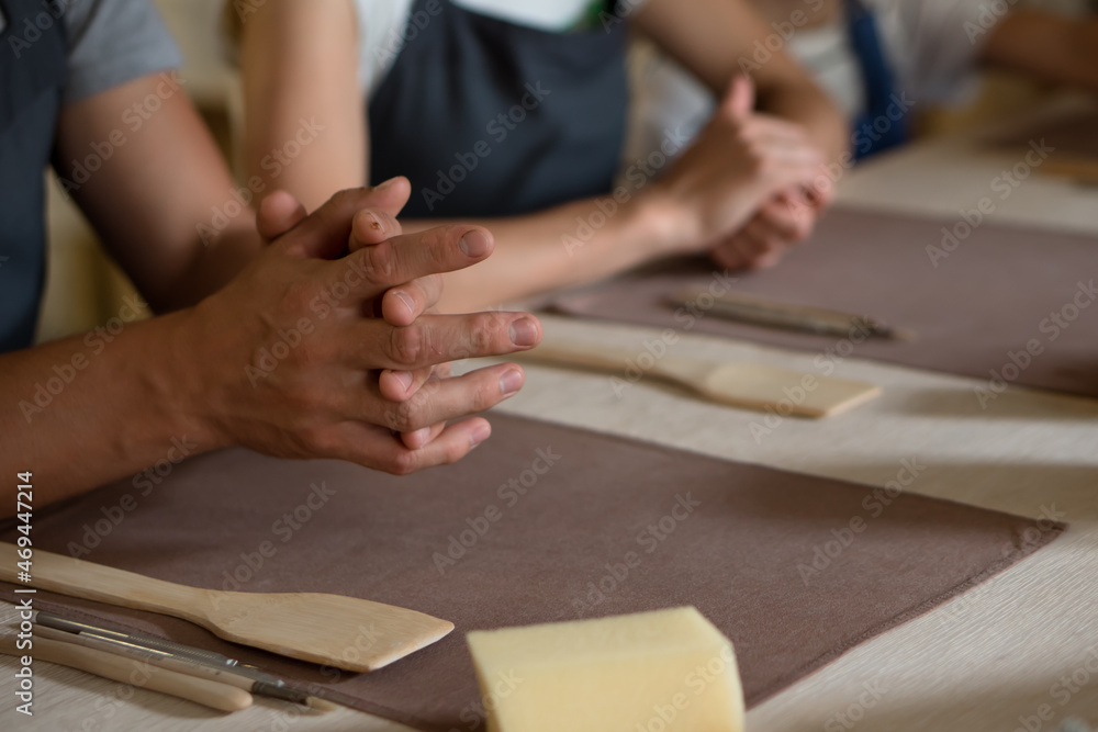 Fototapeta premium Hands of people working in pottery workshop