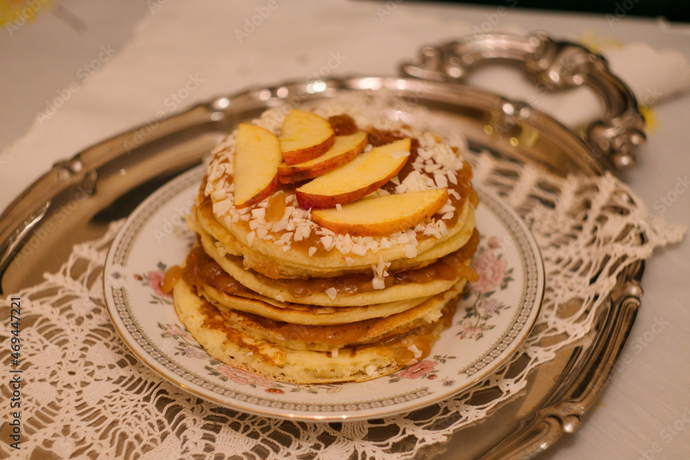 Stack of American apple pancakes with jam, nuts and apples Stack of American apple pancakes with jam, nuts and apples