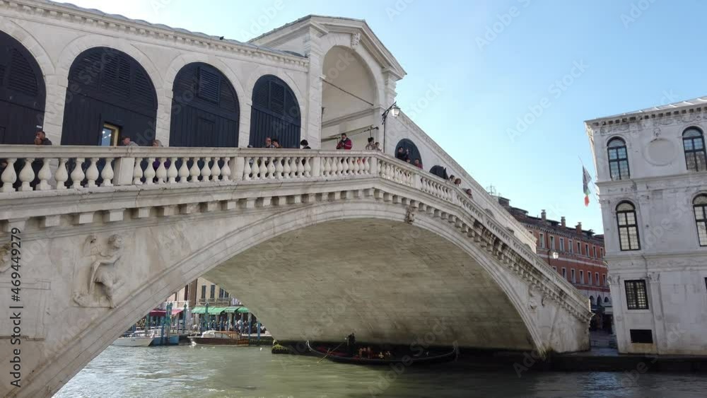 Europe, Italy, Venice November 2021 - Gondolas in Canal Grande with tourist and gondolier in Rialto bridge famous attraction in city of love Europe, Italy, Venice November 2021 - Gondolas in Canal Grande with tourist and gondolier in Rialto bridge famous attraction in city of love