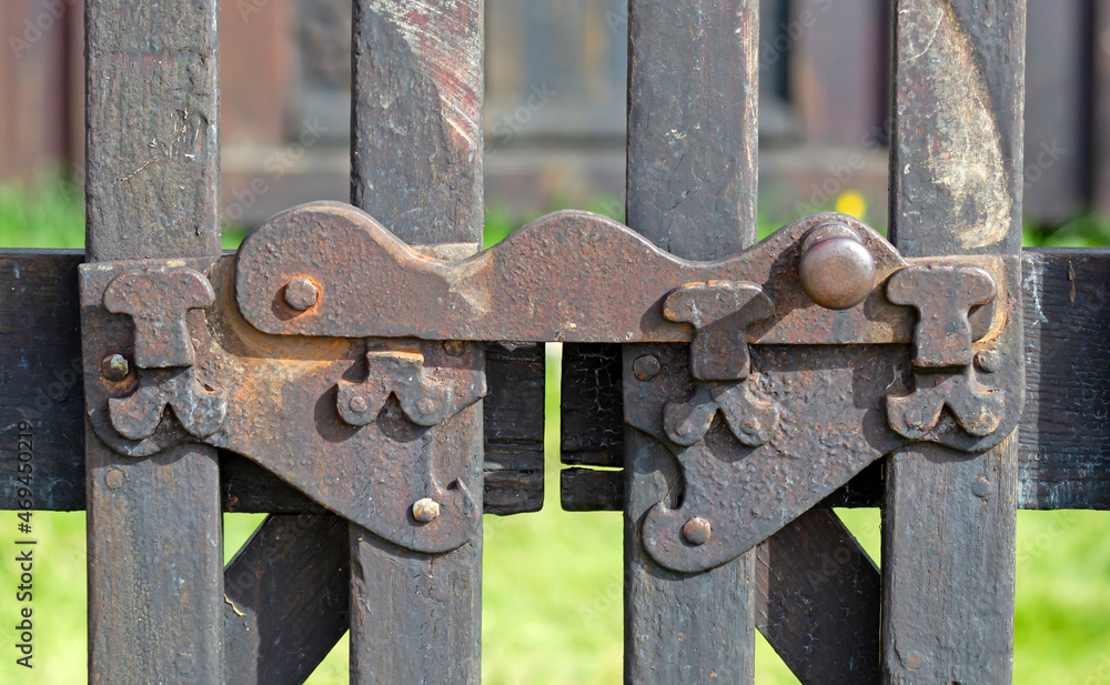Closeup old rusty metal fence, fragment of the lock