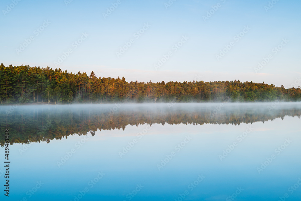 Reflection of lake and forest at sunrise