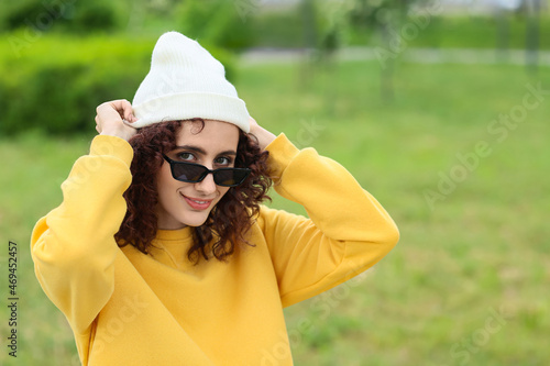 Woman putting on beanie hat...